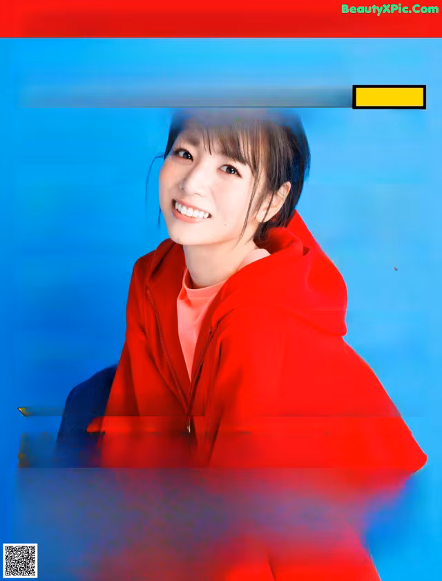 A woman in a red hoodie on the cover of a magazine.
