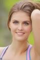 A beautiful young woman with blue eyes posing for a picture.